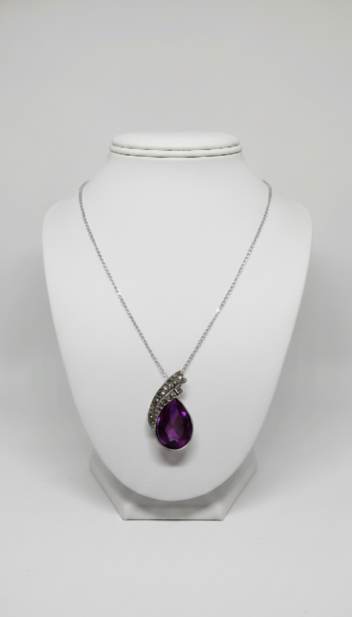 Necklace with a black teardrop pendant on a white mannequin bust.