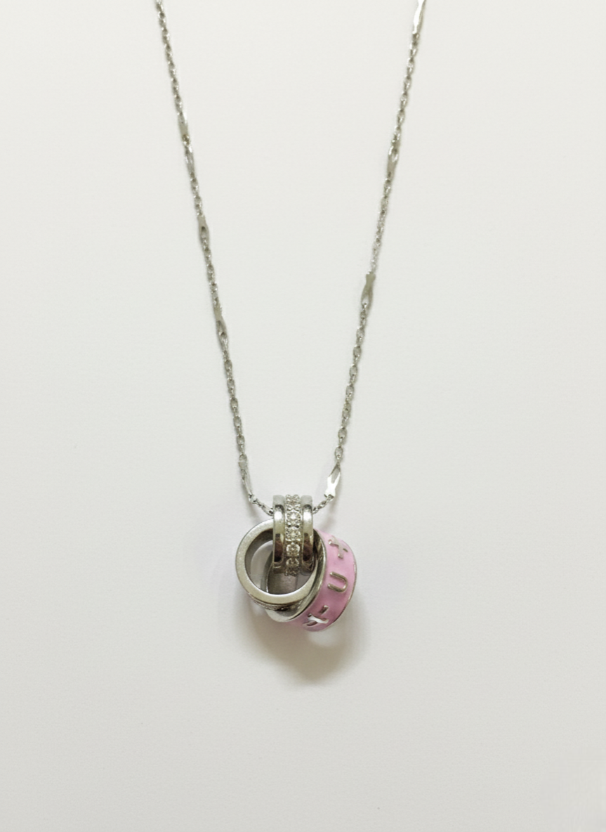 Necklace with a pink and silver pendant on a white background