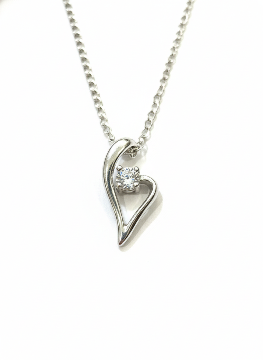 Heart-shaped silver necklace with a diamond on a white background